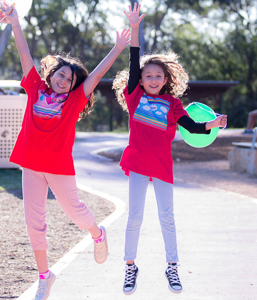 Pick me! Haluna Happy Names colourful tshirts personalised with Arabic option are designed for confidence and joy as these two jumping happy girls in their 'In the Sky' and 'Jewels in my Heart' original t-shirts are showing.